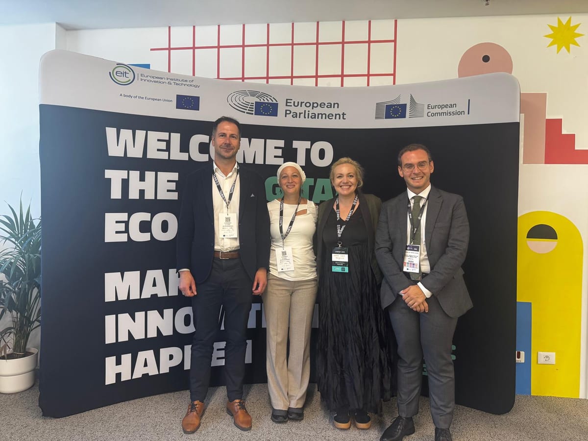 Four people in front of a Welcome banner with EIT, European Parliament and European Commission logos during Bucharest Tech Week
